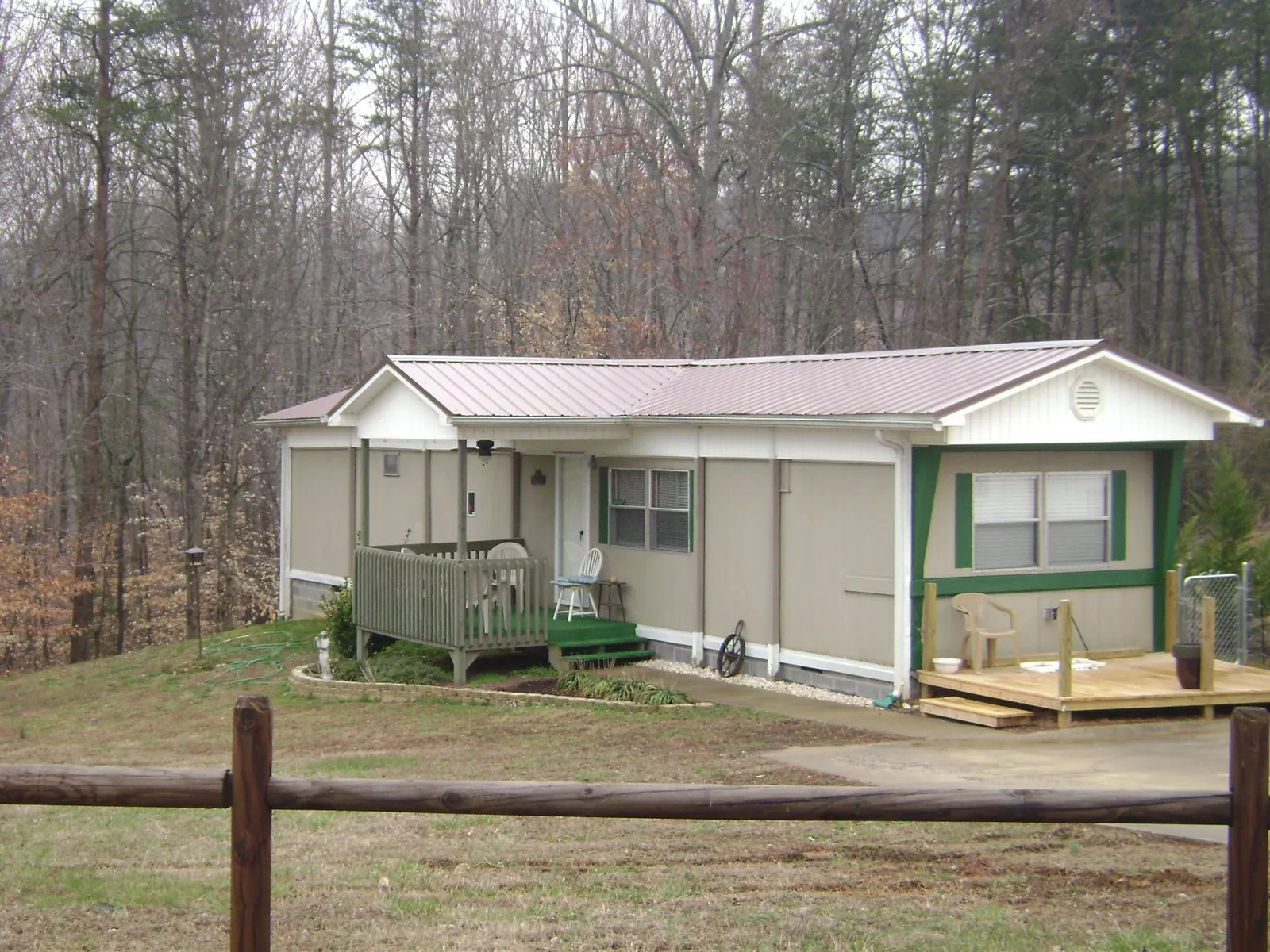 Mauve metal roof on a manufactured home with a new front deck in Columbia
